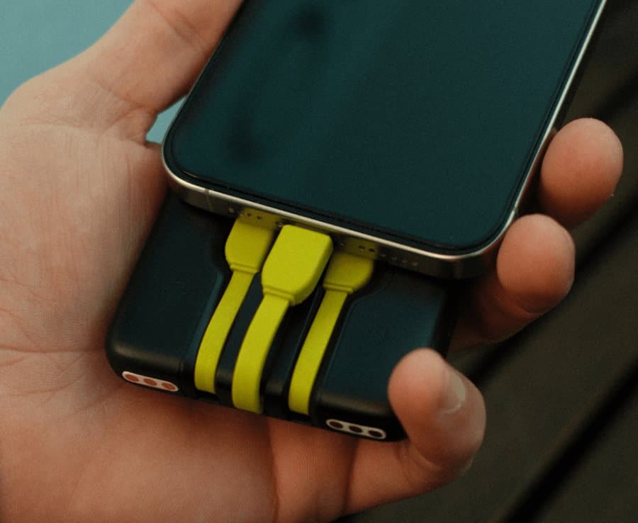 Fluro power bank charging a phone in hand
